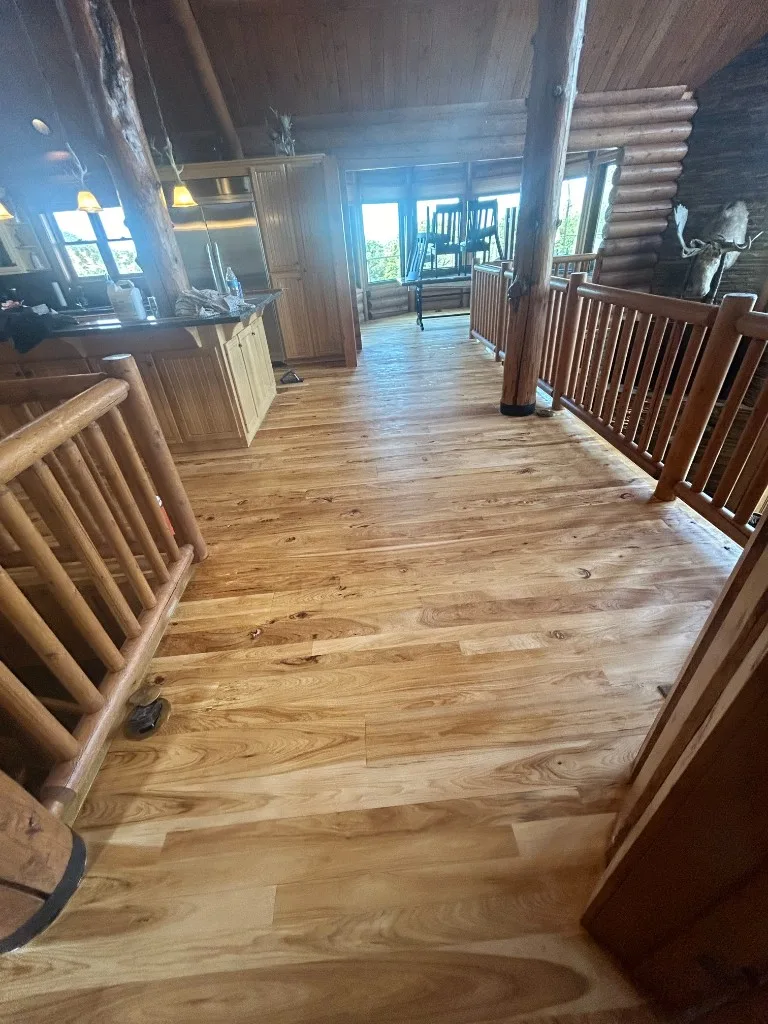 Wide plank hardwood flooring in a rustic log home