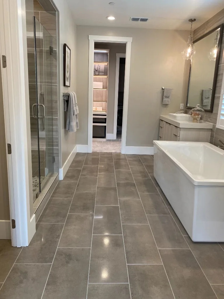 Master bathroom tile installation with shower and vanity