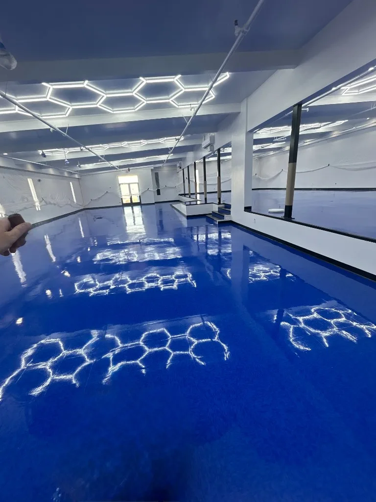 Glossy blue vinyl tile flooring in a fitness studio
